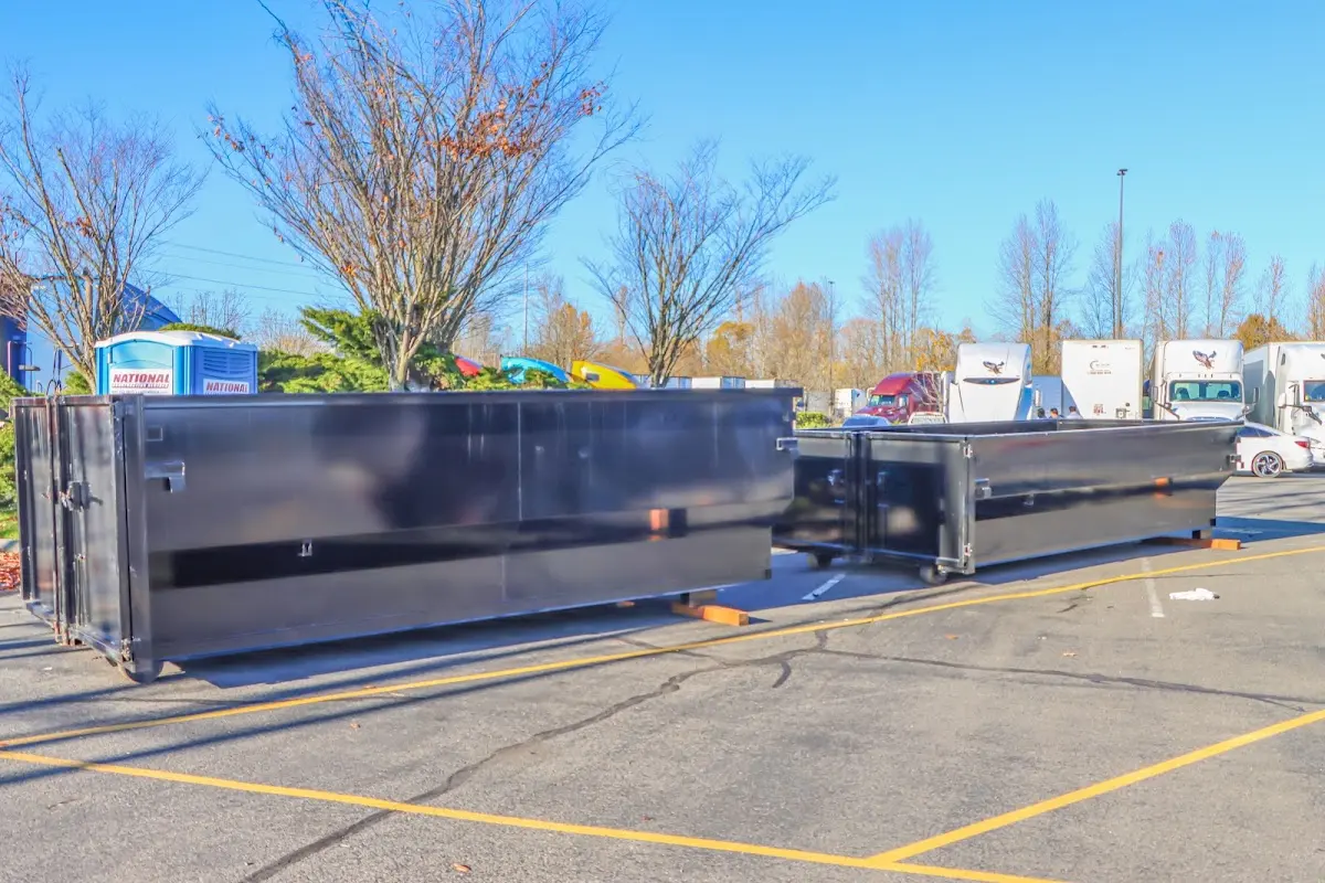 Professional dumpster rental service with roll-off container on residential driveway in Dulles Town Center